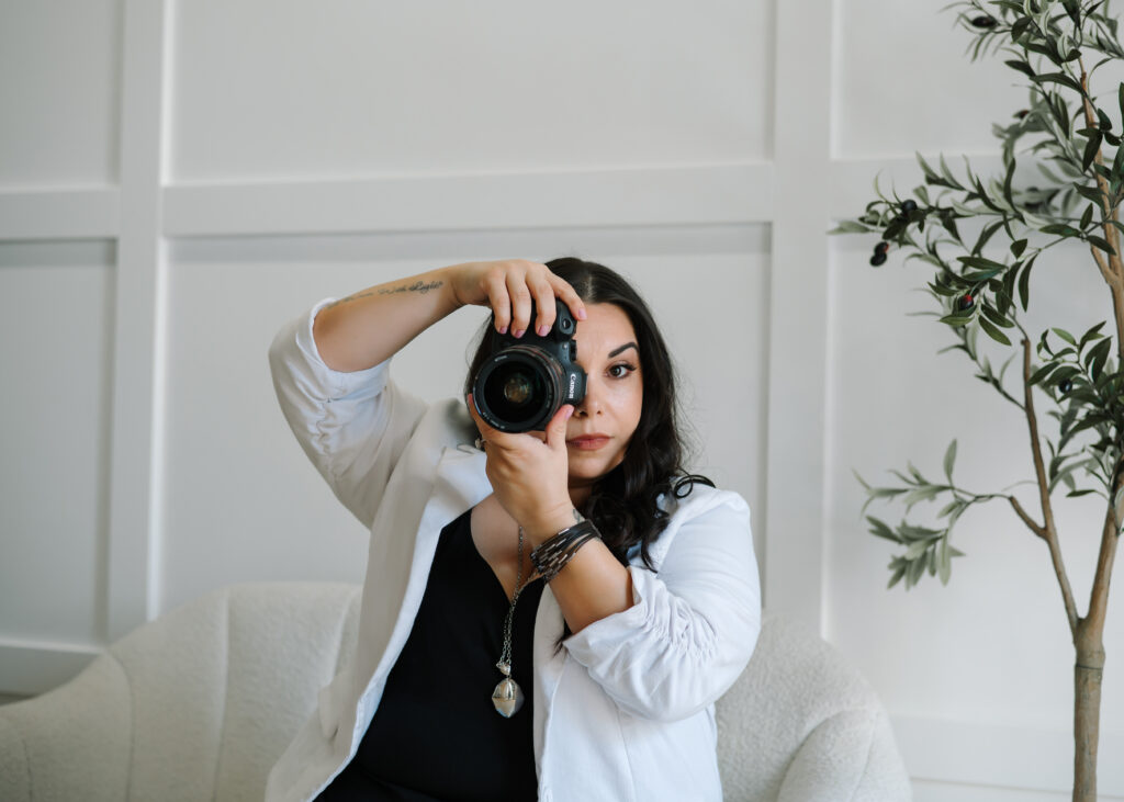 Arizona Boudoir Photographer holding camera in downtown Phoenix Studio